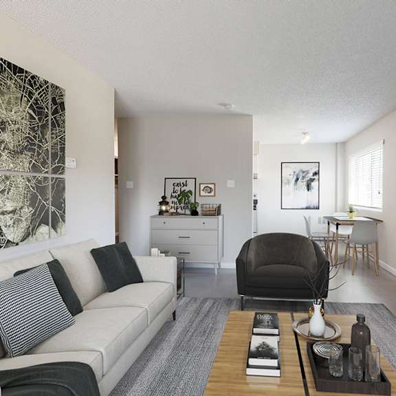 a living room with a couch, a chair, a coffee table, and a large painting on the wall.