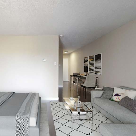 a modern bedroom with a large bed and a grey couch.