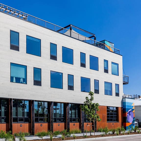 a modern building with a white facade and blue windows.