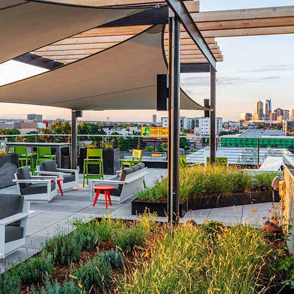 a rooftop patio with a view of the city skyline.