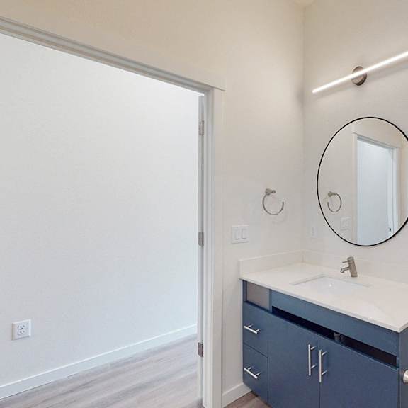 a bathroom with a white sink and a mirror above it.