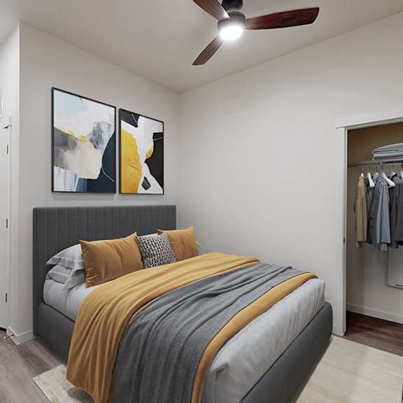 a bedroom with a bed, a ceiling fan, and a wardrobe.