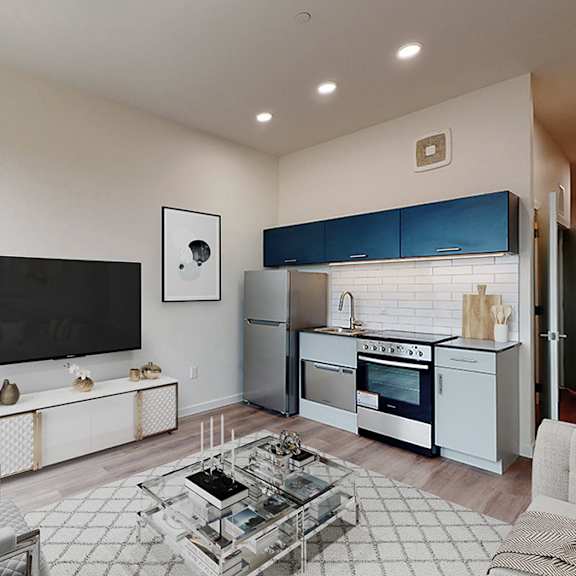 a modern living room with a grey sofa and a glass coffee table.