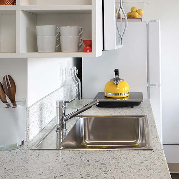 a kitchen with a sink and a refrigerator.
