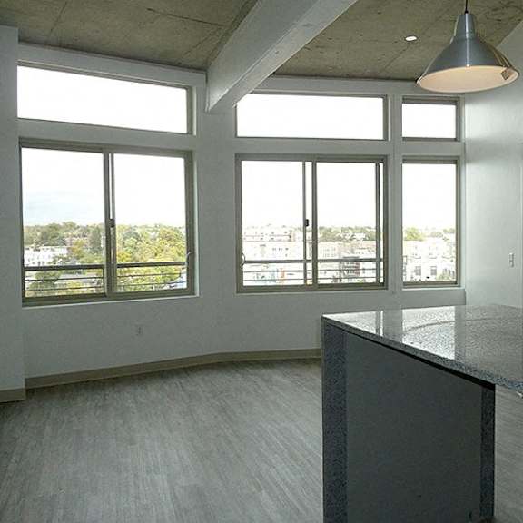 a large empty room with a concrete floor and a long counter.