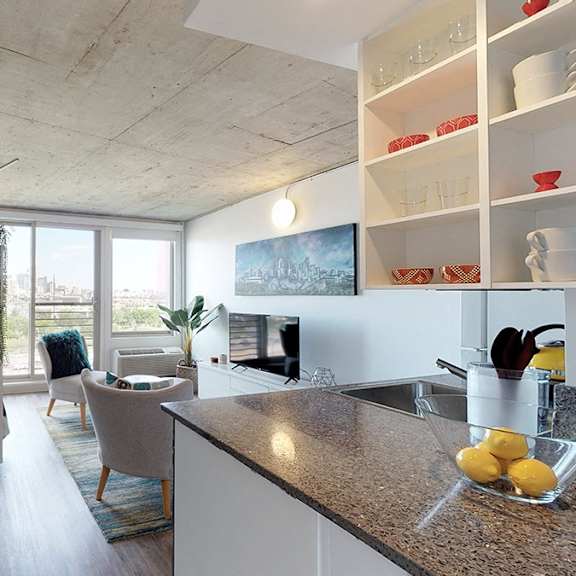 a kitchen with a counter top and a bowl of lemons on it.