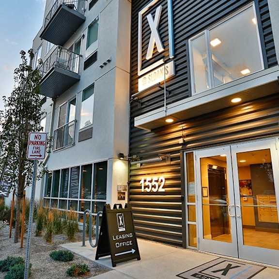 a modern building with a leasing office and a no parking sign.