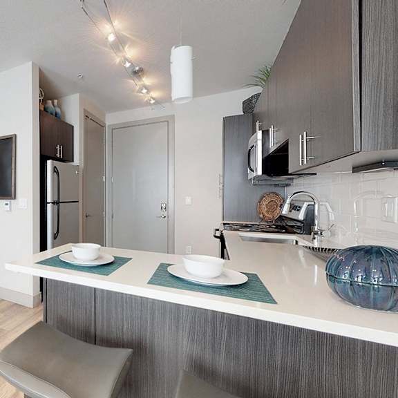 a modern kitchen with a dining table and chairs.