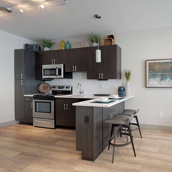 a modern kitchen with dark wood cabinets and a large island.