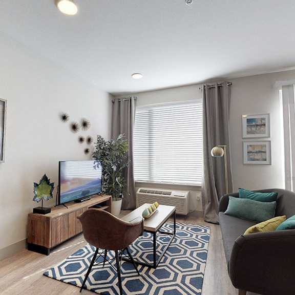 a living room with a brown chair and a blue and white rug.