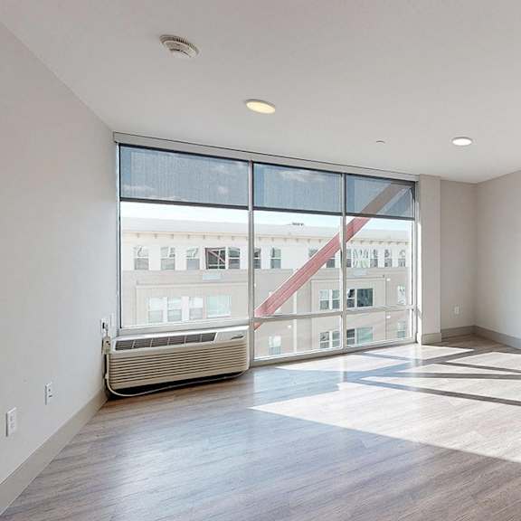 a modern kitchen with a large window overlooking a cityscape.