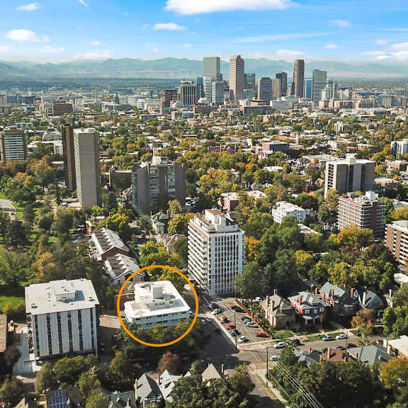 a cityscape with a large building circled in the middle.