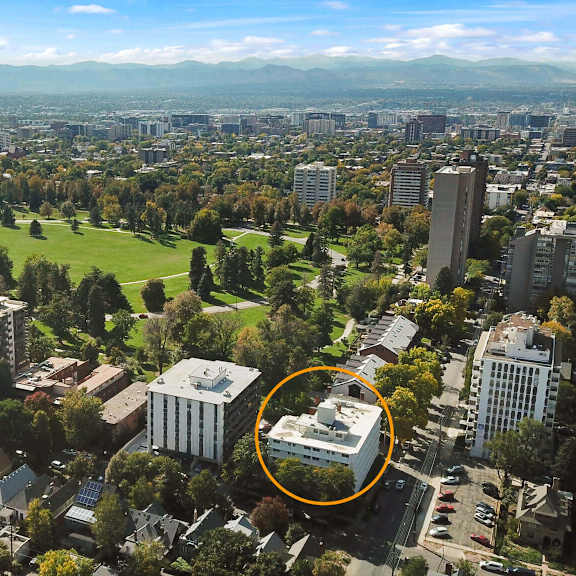 an aerial view of a city with a large building circled in orange.