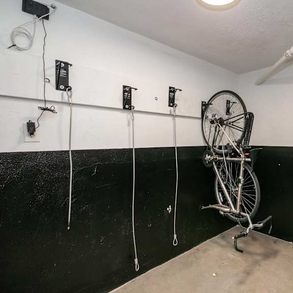 a bicycle is leaning against a wall in a room with black walls and white ceiling.