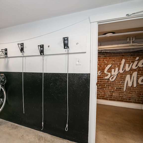 a bicycle is hanging on a wall hook.