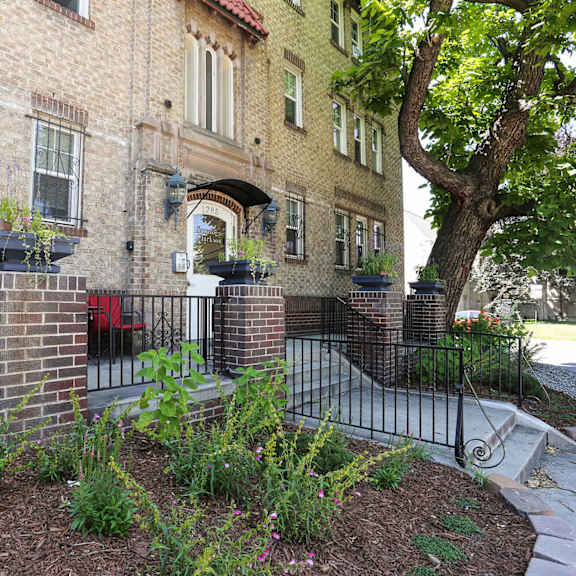 a brick building with a red chair in front of it.