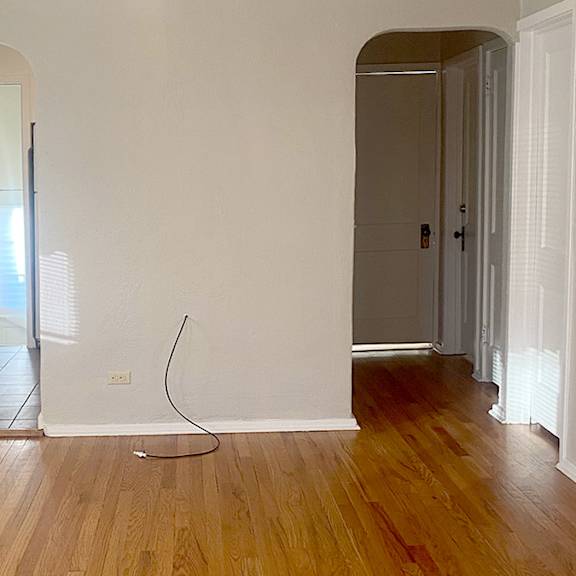 a room with wooden floors and white walls.