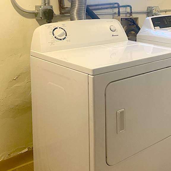 a white washing machine and dryer in a laundry room.