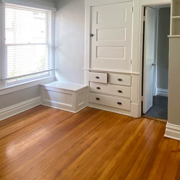a room with a wooden floor and a white door.