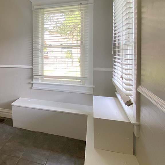 a white door is in the middle of a room.