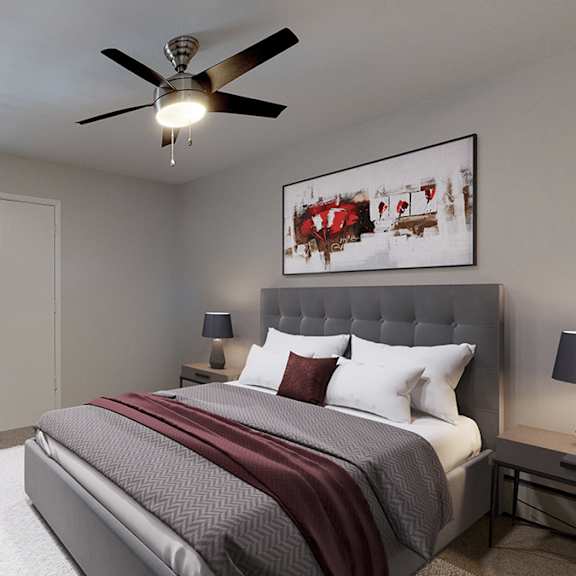a bedroom with a large bed and a ceiling fan.
