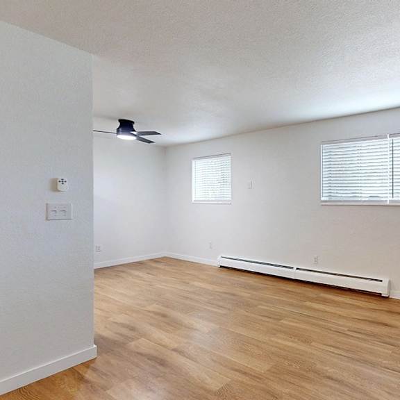a room with a window and a ceiling fan.