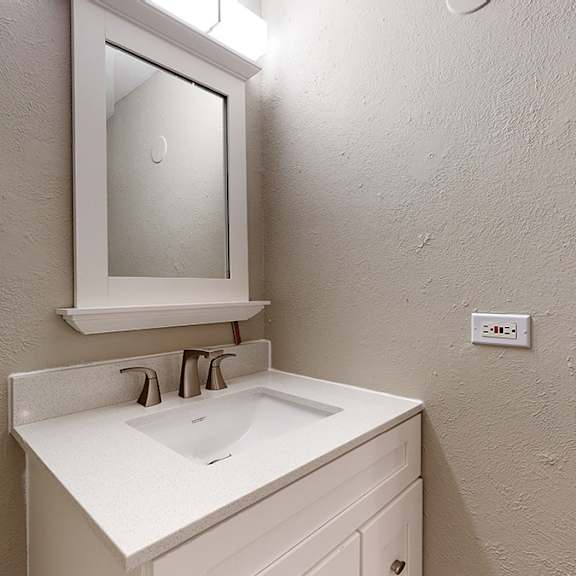 a bathroom sink with a mirror above it.