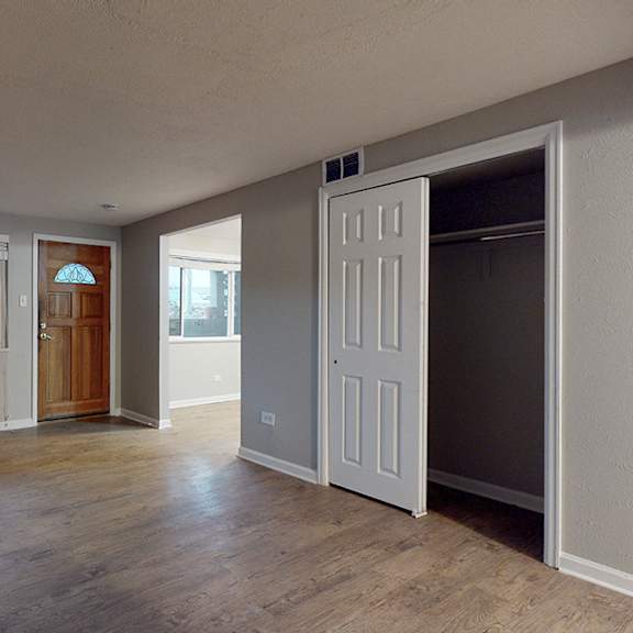 a room with a wooden floor and a white door.