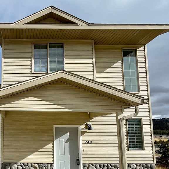 a two-story house with a garage on the first floor.