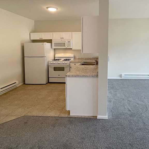 a kitchen with white appliances and a countertop.