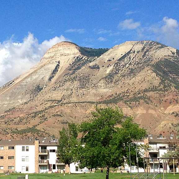 a mountain with a cloud of smoke rising from its peak.