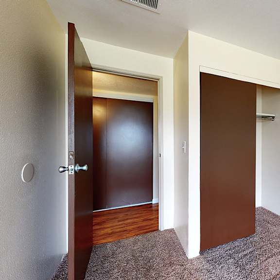 a room with a brown door and a white door.