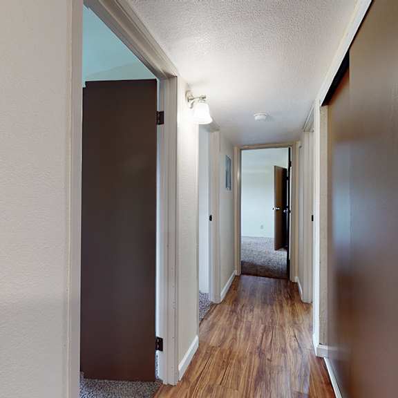 a hallway with a light switch on the wall.