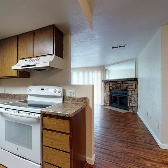 a kitchen with white appliances and wooden cabinets.