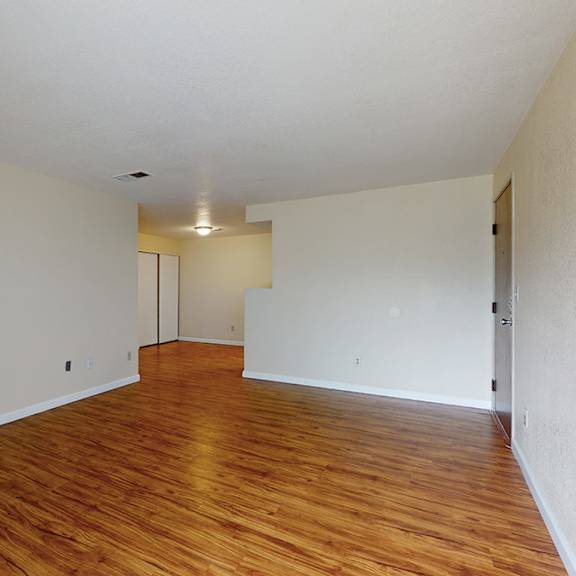 a room with a fireplace and wood flooring.