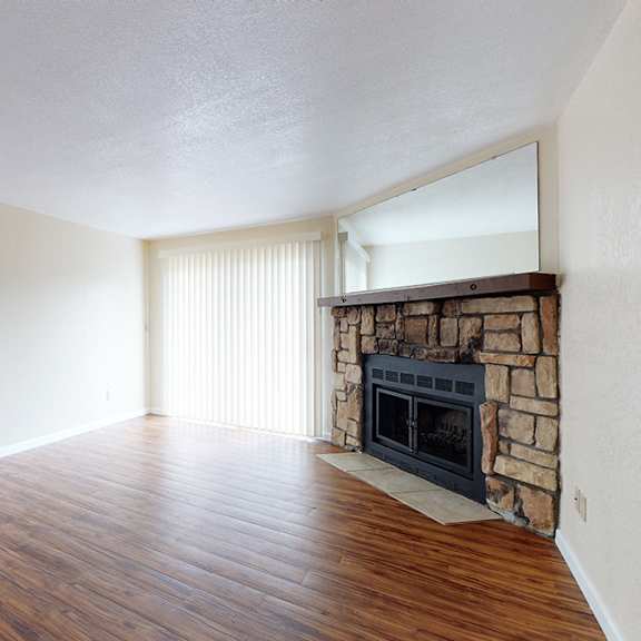 a room with a fireplace and a mirror on the wall.