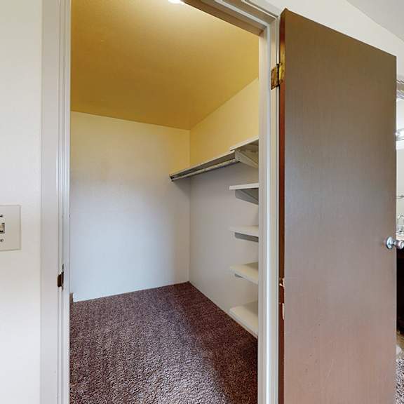a room with a brown carpet and a brown door.