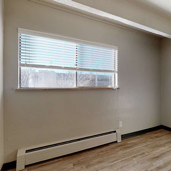 a room with a window and a radiator on the floor.