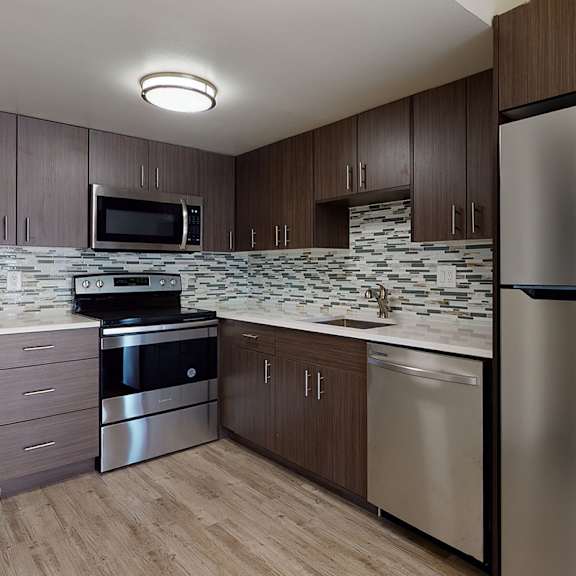 a modern kitchen with a stainless steel refrigerator.