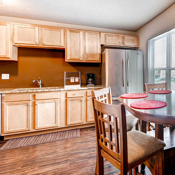 a kitchen with a table and chairs.