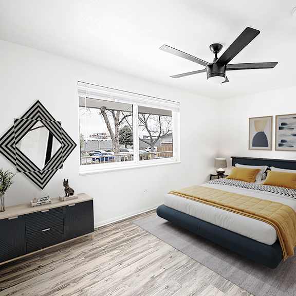 a bedroom with a bed, nightstand, and a ceiling fan.