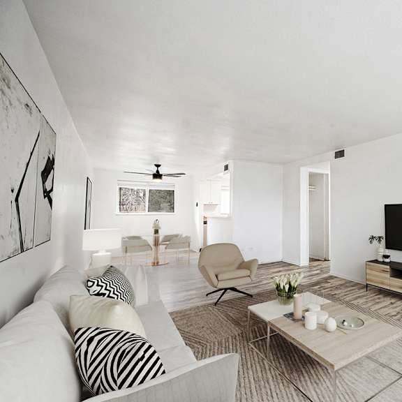 a living room with a white couch and a television.