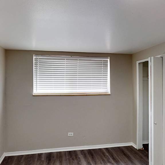 bedroom with a window and a door.