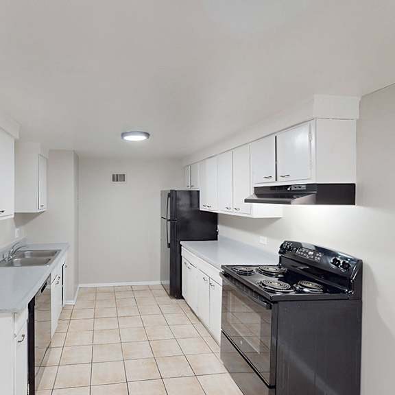 a kitchen with white cabinets and black appliances.