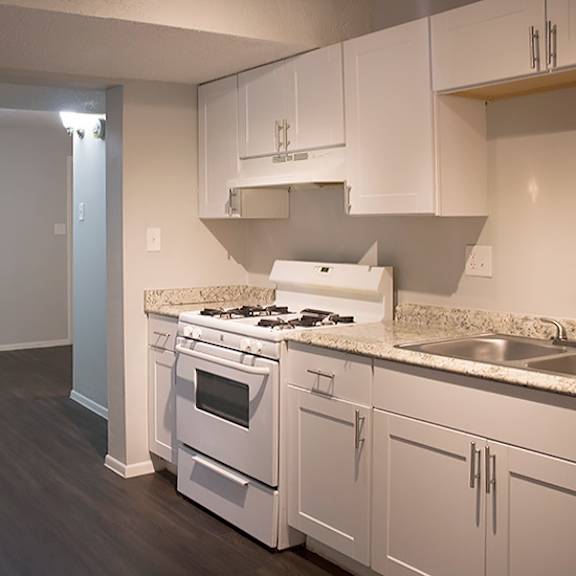 a kitchen with white appliances and cabinets.