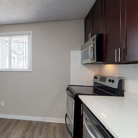 a kitchen with a white counter top and a black oven.