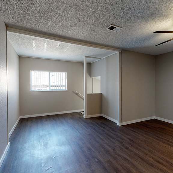 a room with a ceiling fan and a window.