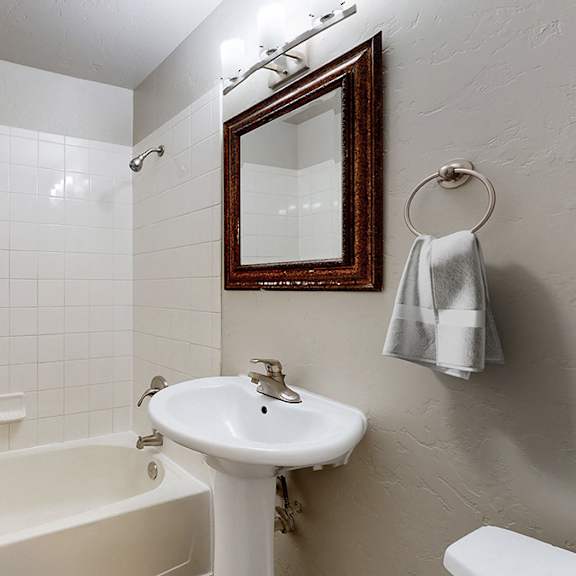 a bathroom with a white sink and a white bathtub.