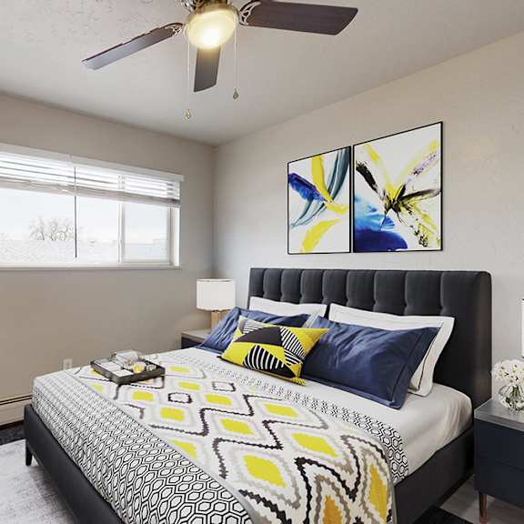 a bedroom with a bed, nightstands, and a ceiling fan.