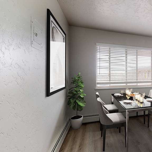a dining room with a table set for four.